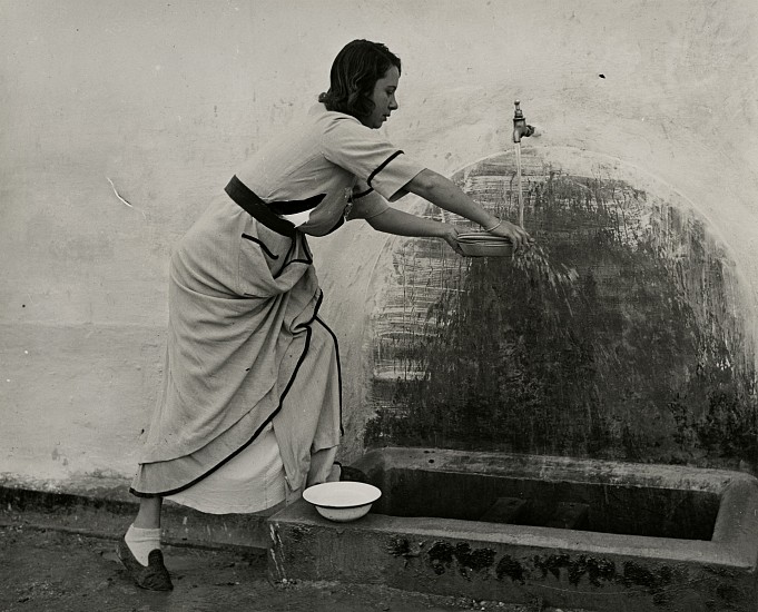 Eliot Elisofon, Concentration Camp in French Morocco, 1942
Vintage gelatin silver print, 7 1/216 x 9 1/4 in. (17.8 x 23.5 cm)
Italian Woman at Water Faucet in Courtyard.
(Sold as part of a group of 18 prints)
6106