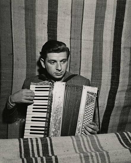 Eliot Elisofon, Concentration Camp in French Morocco, 1942
Vintage gelatin silver print, 9 1/4 x 7 7/16 in. (23.5 x 18.9 cm)
Camp Doctor Landesberg plays accordion for accompaniment.
(Sold as part of a group of 18 prints)
6123