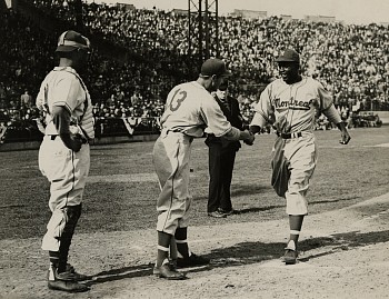 Work: Shuba shakes hands with Robinson after his first home run